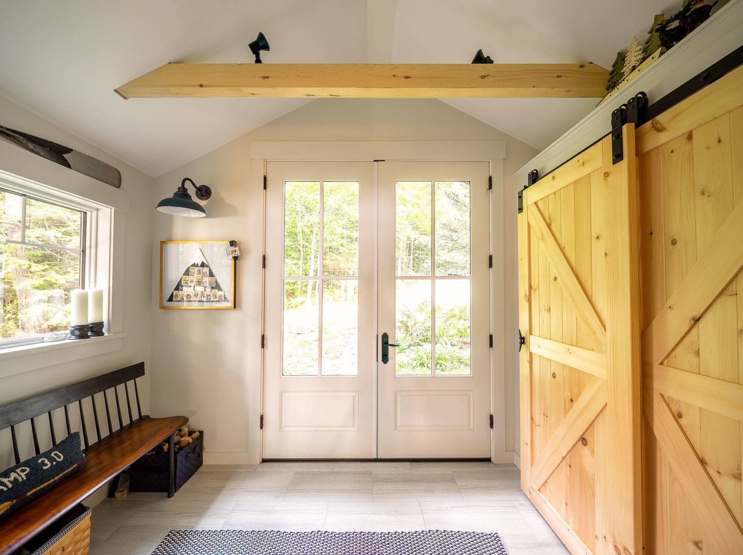 Mudroom with custom-built barn doors, designed to prevent the doors from swinging into the room at EP Lakehouse